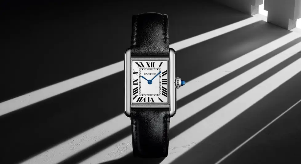 vintage cartier tank watch with rectangular case, roman numerals, and blue steel hands
